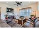 Comfortable living room featuring neutral walls, a ceiling fan, and a large window at 16658 Prospect Ln, Broomfield, CO 80023