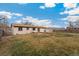 Fenced backyard featuring a well-maintained lawn and a storage shed at 2916 S Jasper St, Aurora, CO 80013