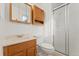 Standard bathroom featuring a vanity with sink, toilet, medicine cabinet, and shower with glass door at 2916 S Jasper St, Aurora, CO 80013