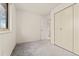 Bright bedroom with window and closet with view into the bathroom at 2916 S Jasper St, Aurora, CO 80013