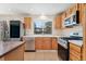 Well-equipped kitchen with stainless appliances, light wood cabinets, and a large window over the sink at 2916 S Jasper St, Aurora, CO 80013