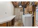 Unfinished basement laundry room with modern appliances and storage at 2916 S Jasper St, Aurora, CO 80013