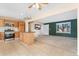 Inviting living area adjoining a kitchen, complete with modern appliances and stylish cabinetry at 2916 S Jasper St, Aurora, CO 80013