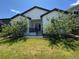 Exterior of the home, featuring a small backyard with trees, a patio, and a well-kept lawn at 4391 Mcmurdo Ct, Castle Rock, CO 80108