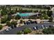 Aerial view showcasing a sparkling community pool, surrounded by lush landscaping and ample parking at 4391 Mcmurdo Ct, Castle Rock, CO 80108