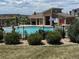 Community pool with lounge chairs, umbrellas, and well maintained landscaping for a refreshing neighborhood retreat at 4391 Mcmurdo Ct, Castle Rock, CO 80108