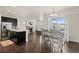 Open-concept living room with hardwood floors, a fireplace, and a dining area near the kitchen at 4391 Mcmurdo Ct, Castle Rock, CO 80108