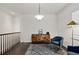 Stylish loft space with hardwood floors, a blue armchair, and a decorative console table at 4391 Mcmurdo Ct, Castle Rock, CO 80108