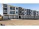 Contemporary townhome featuring modern design with individual garages and black iron balcony railings at 6153 N Ceylon St # 104, Denver, CO 80249