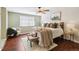 Spacious bedroom with ceiling fan, plush bedding, and hardwood floors at 14022 W Alaska Dr, Lakewood, CO 80228