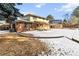 Brick house exterior with snow-covered backyard and shed at 14022 W Alaska Dr, Lakewood, CO 80228