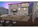 Exterior view of a backyard with a deck, a grassy area, and a two-story home in the background at 12663 Buffington Trl, Parker, CO 80134