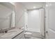 Bright bathroom with a shower-tub combo, white tile and a vanity with a sink and gray countertop at 12663 Buffington Trl, Parker, CO 80134