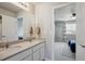 Double sink bathroom leading to a bedroom, featuring a large mirror and tile flooring at 12663 Buffington Trl, Parker, CO 80134