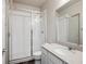 Modern bathroom featuring a walk-in shower with glass doors and a sink with stone countertops at 12663 Buffington Trl, Parker, CO 80134