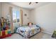 Cozy ' bedroom with carpet, a window, and a playful city themed bedspread at 12663 Buffington Trl, Parker, CO 80134