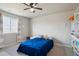 Bedroom featuring a bed with a blue comforter and a bright window allowing natural light at 12663 Buffington Trl, Parker, CO 80134