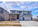 Charming two-story home featuring a stone facade, three-car garage, and a well-manicured front yard at 12663 Buffington Trl, Parker, CO 80134