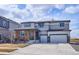 Charming two-story home featuring a stone facade, three-car garage, and a well-manicured front yard at 12663 Buffington Trl, Parker, CO 80134