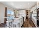 Modern kitchen island with stainless steel appliances and adjacent outdoor deck access at 12663 Buffington Trl, Parker, CO 80134