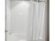 Shower featuring white tiled walls, a shower curtain and a shower-tub combo at 12663 Buffington Trl, Parker, CO 80134