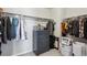 Organized walk-in closet featuring a gray dresser with shelving and hanging racks for optimal storage at 12663 Buffington Trl, Parker, CO 80134