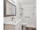 Modern bathroom featuring a white vanity and a tiled shower at 10150 E Virginia Ave # 7-204, Denver, CO 80247