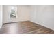 Bright and airy bedroom with wood floors and a large window at 10150 E Virginia Ave # 7-204, Denver, CO 80247