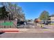 Welcoming entrance to Oak Park community, featuring secure gates and a professionally landscaped stone sign at 10150 E Virginia Ave # 7-204, Denver, CO 80247