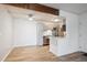 Eat in kitchen with stainless steel appliances, gray cabinetry, updated lighting, and natural wood beam at 10150 E Virginia Ave # 7-204, Denver, CO 80247