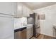 Modern kitchen featuring white countertops, a stainless steel refrigerator, and wood floors at 10150 E Virginia Ave # 7-204, Denver, CO 80247