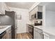 Cozy kitchen with stainless steel appliances and gray cabinetry at 10150 E Virginia Ave # 7-204, Denver, CO 80247