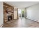 Inviting living room features a stone fireplace, wood-style flooring, and a sliding glass door to a balcony at 10150 E Virginia Ave # 7-204, Denver, CO 80247