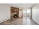 Bright living room includes modern floors, stone fireplace, and access to a balcony with natural light at 10150 E Virginia Ave # 7-204, Denver, CO 80247