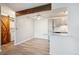 Open living space with modern flooring, a barn door, and an eat in kitchen with updated cabinets and appliances at 10150 E Virginia Ave # 7-204, Denver, CO 80247