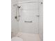Bathroom shower with tile surround and built in shelving at 10150 E Virginia Ave # 7-204, Denver, CO 80247