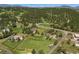 Scenic aerial view of houses dotted across a green landscape, with towering mountains visible in the background at 713 Aspen Rd, Golden, CO 80401