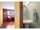 Partial view of a bathroom featuring a sink with a decorative mirror and a shared wall with the adjacent room at 713 Aspen Rd, Golden, CO 80401