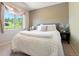 Bedroom featuring a large bed, plush bedding, and a window with natural light and scenic view at 713 Aspen Rd, Golden, CO 80401