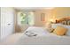 Cozy bedroom with a queen bed with yellow pillows, a window view, and a closet at 713 Aspen Rd, Golden, CO 80401