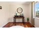 Bedroom features hardwood floors, white rug, large mirror and writing desk in a brightly lit room with a large window at 713 Aspen Rd, Golden, CO 80401