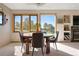 Bright dining area featuring a round wood table, four chairs, and large windows offering scenic views at 713 Aspen Rd, Golden, CO 80401