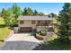 Charming home with a two-car garage, deck, and landscaped front yard at 713 Aspen Rd, Golden, CO 80401