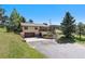 Inviting home with a two-car garage and front yard with mature trees at 713 Aspen Rd, Golden, CO 80401