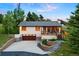 Charming home featuring a two-car garage, a welcoming porch, and landscaped steps to the entry way at 713 Aspen Rd, Golden, CO 80401