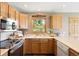 A well-lit kitchen showcasing wood cabinets, stainless steel appliances, and lots of counter space at 713 Aspen Rd, Golden, CO 80401