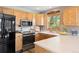 Bright kitchen featuring stainless steel appliances, wooden cabinetry, and ample counter space at 713 Aspen Rd, Golden, CO 80401