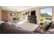 Cozy living room with a fireplace, dining area, and lots of windows at 713 Aspen Rd, Golden, CO 80401