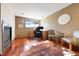 Bright office space with fireplace, hardwood floors, desk and two chairs with window view and unique cowhide rug at 713 Aspen Rd, Golden, CO 80401