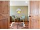 Inviting seating area features hardwood floors, a hide rug, and two light green chairs with an accent table at 713 Aspen Rd, Golden, CO 80401